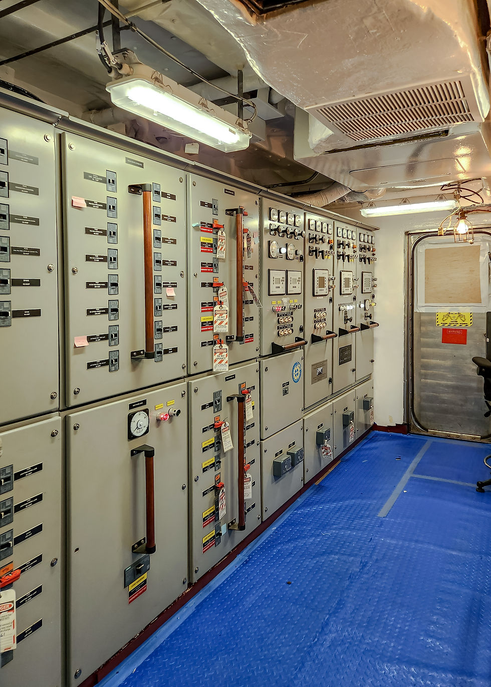 Eye-level view of a marine engine room with installed power switchboards