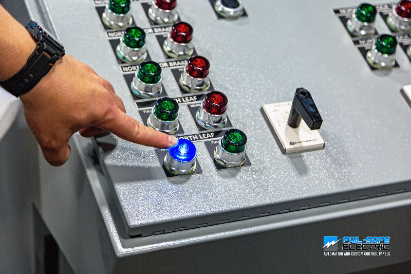 Close-up view of custom industrial control panel with labeled switches and wiring