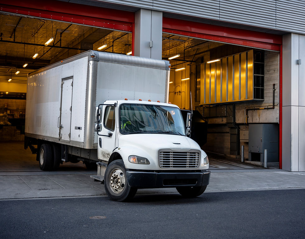 The middle-duty white day cab compact semi truck for local shipping and delivery services