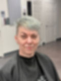 Woman with short silver hair at a Toledo hair salon booth