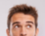 Person with styled hair looking up in a Toledo hair salon