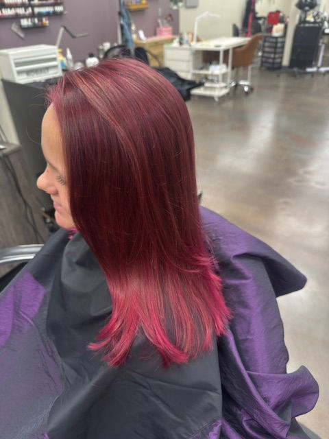 Vibrant red hair color at a Toledo hair salon booth suite.