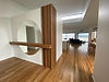 Modern home interior with hardwood flooring and circular mirror