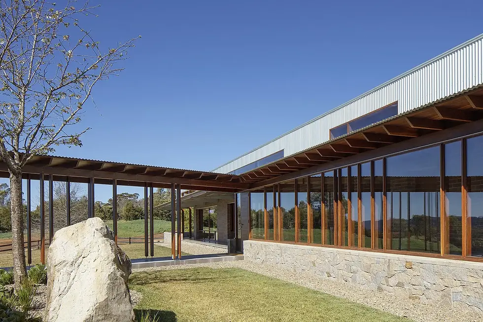 Modern house with large windows and stone wall