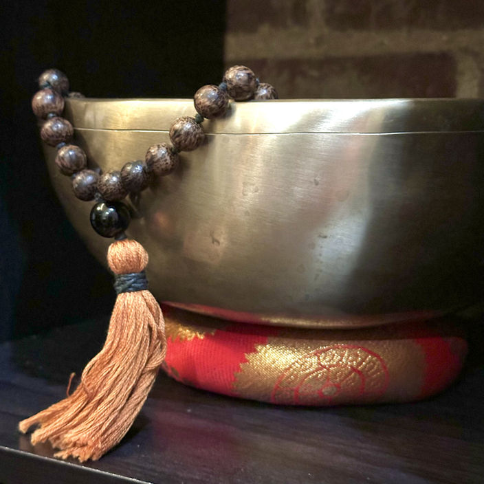 Metal sound healing bowl with a mala