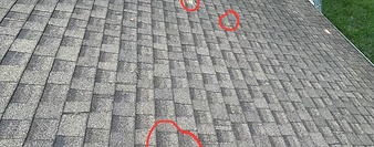 A handful of missing shingles on a roof.