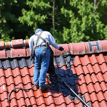 A worker on a roof applying a waterproof coating.jpg
