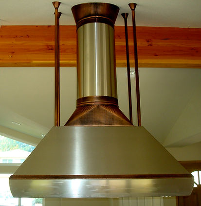Stainless steel custom kitchen island hood with copper accents