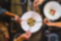 Group of friends picking up a traditional gyoza dumpling at a Japanese fusion restaurant -
