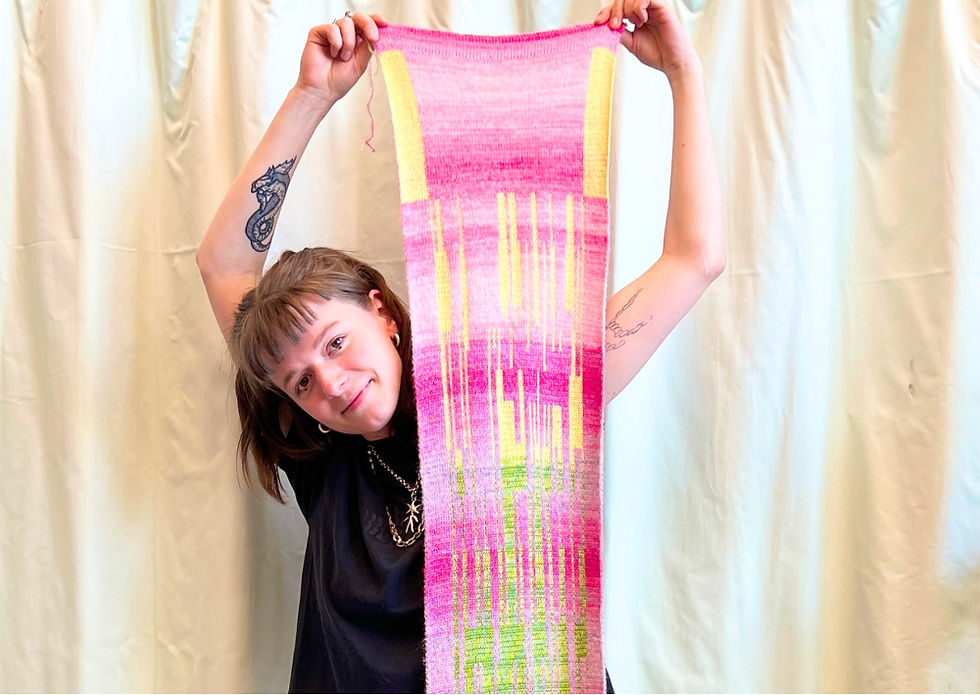 Kursteilehmerin zeigt gestrickten Schal in Jacquard Technik, den sie im Strickmaschine Workshop Basis gestrickt hat
