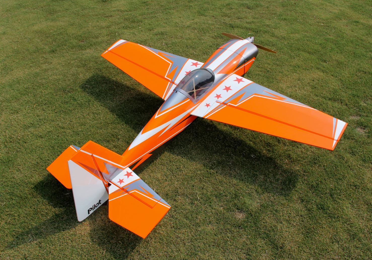 Top view on the ground of Pilot-RC Laser 67" Orange/Silver