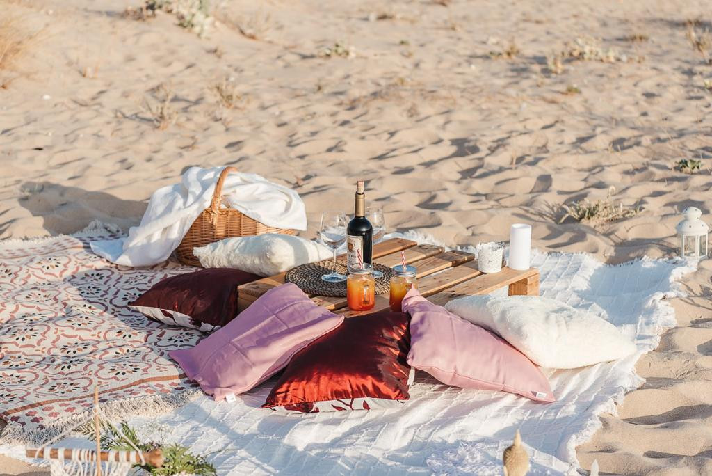 Relax picnic with blankets and cushions on the beach