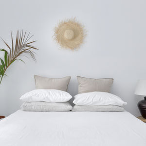 a bed with a tropical blanket and pillows on it