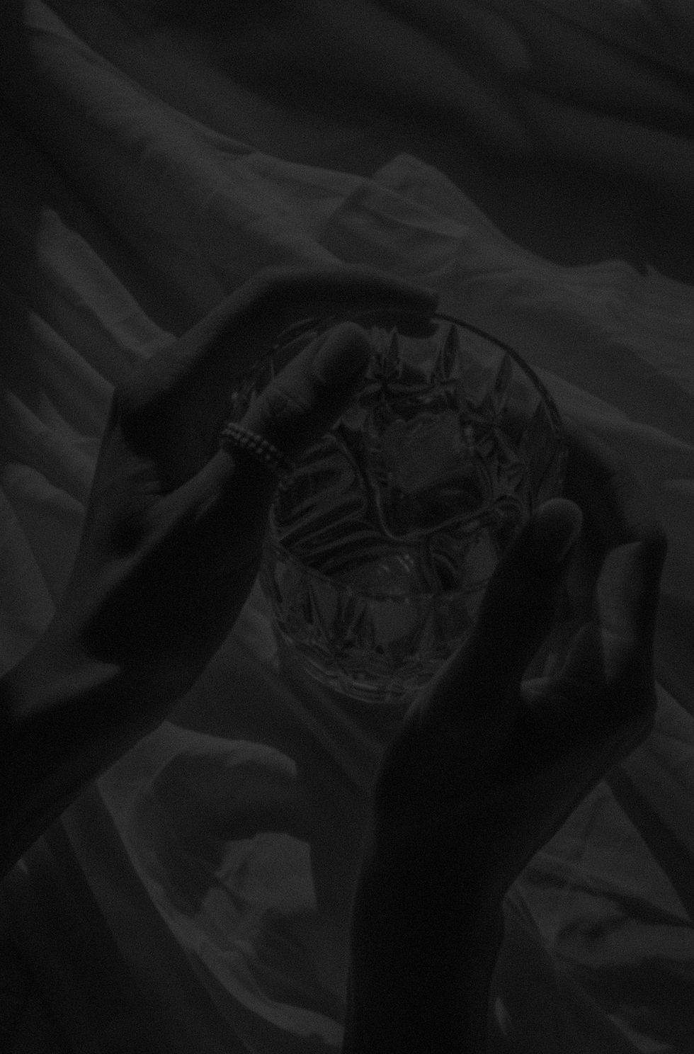 hands_holding_crystal_glass_with_ice_edited.jpg