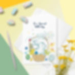 Easter card for a boy featuring a white bunny in a basket, surrounded by spring flowers and Easter eggs.