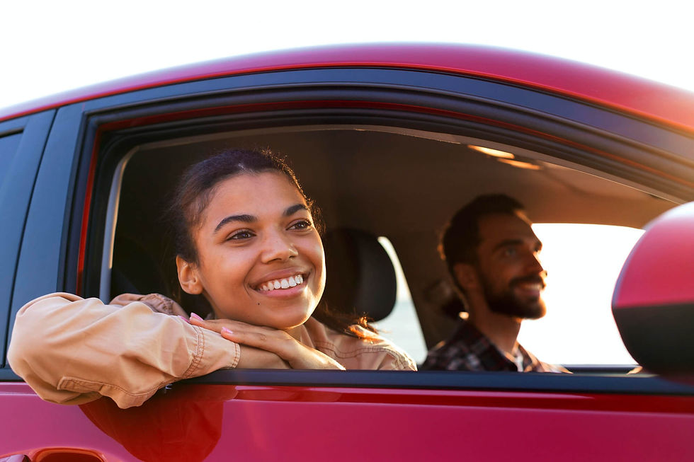 Smiling couple driving in a Hull Auto Prestige car
