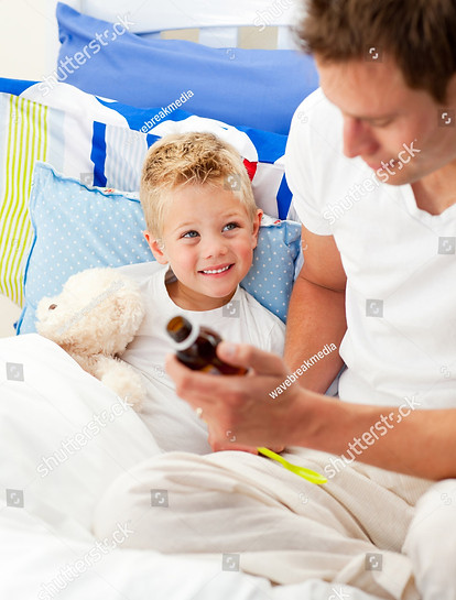 stock-photo-handsome-father-giving-cough-syrup-to-his-sick-son-sitting-on-bed-47445454.jpg