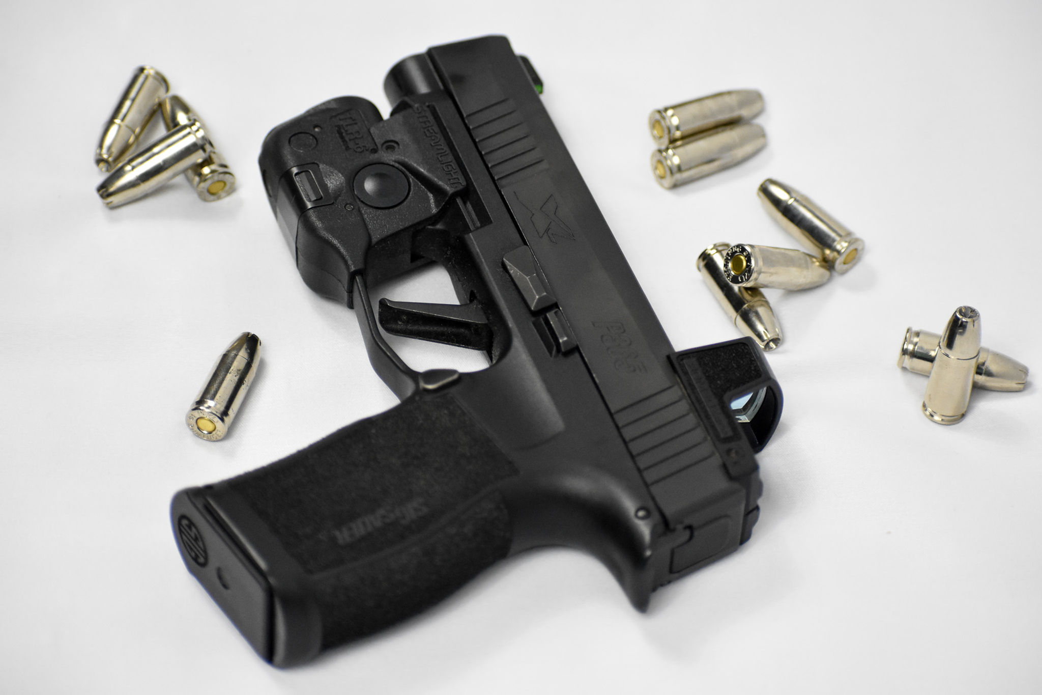 Image of pistol laying down with bullets