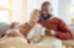 Couple enjoying heating in their living room on a cold day