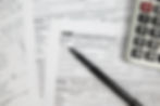 Tax form 1040, calculator, and pen: HAA&P CPA tax services