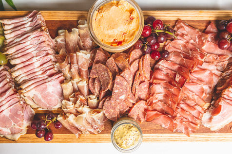 Charcuterie Display with house cured meats and pickles, crackers and mustards