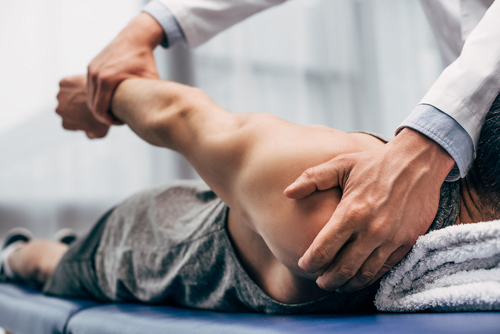 Chiropractor treating a patient’s shoulder at Greenway Health Center in Raleigh, NC