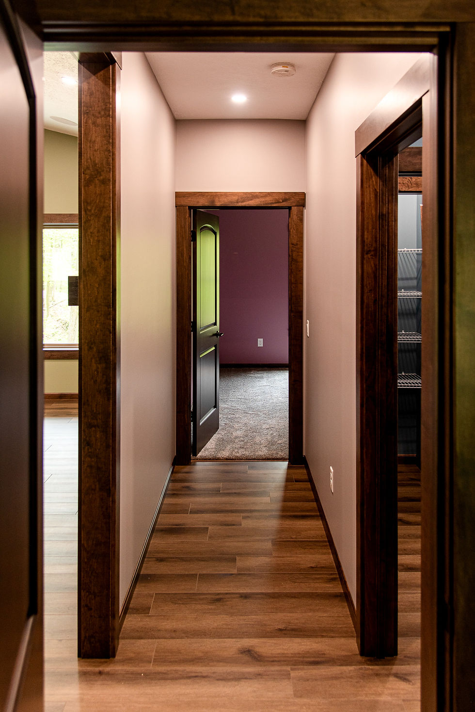 Interior hallway with hardwood floors and dark wood trim.