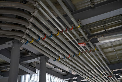 Neatly organized electrical lines and conduits, ensuring a safe and efficient wiring system in a commercial or industrial setting.