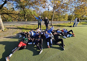 boys' team posing on green turf at a park