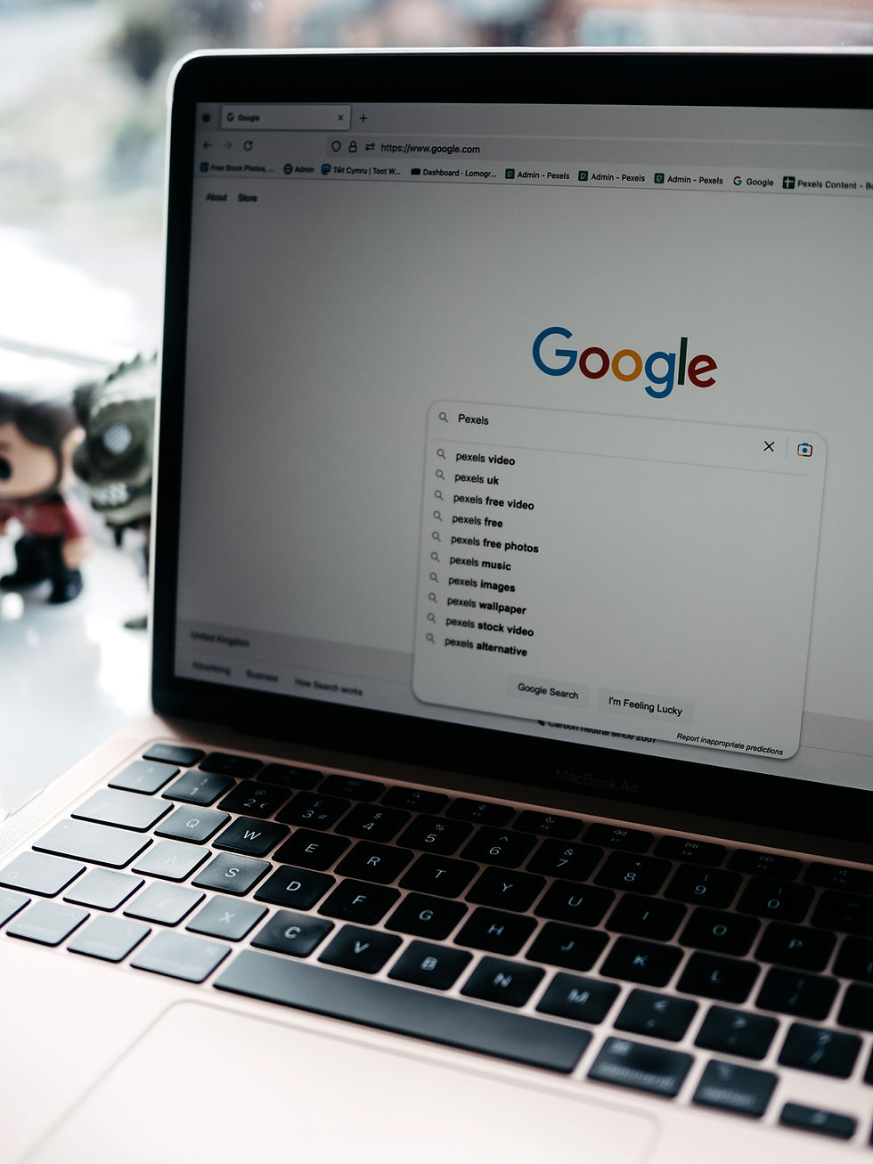 Laptop displaying Google search suggestions while researching keywords for a B2B SEO strategy.