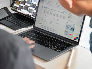 Content writer working on SEO content for AI search using a laptop and tablet.