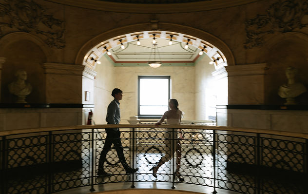 Couple walking through muesum hand in hand