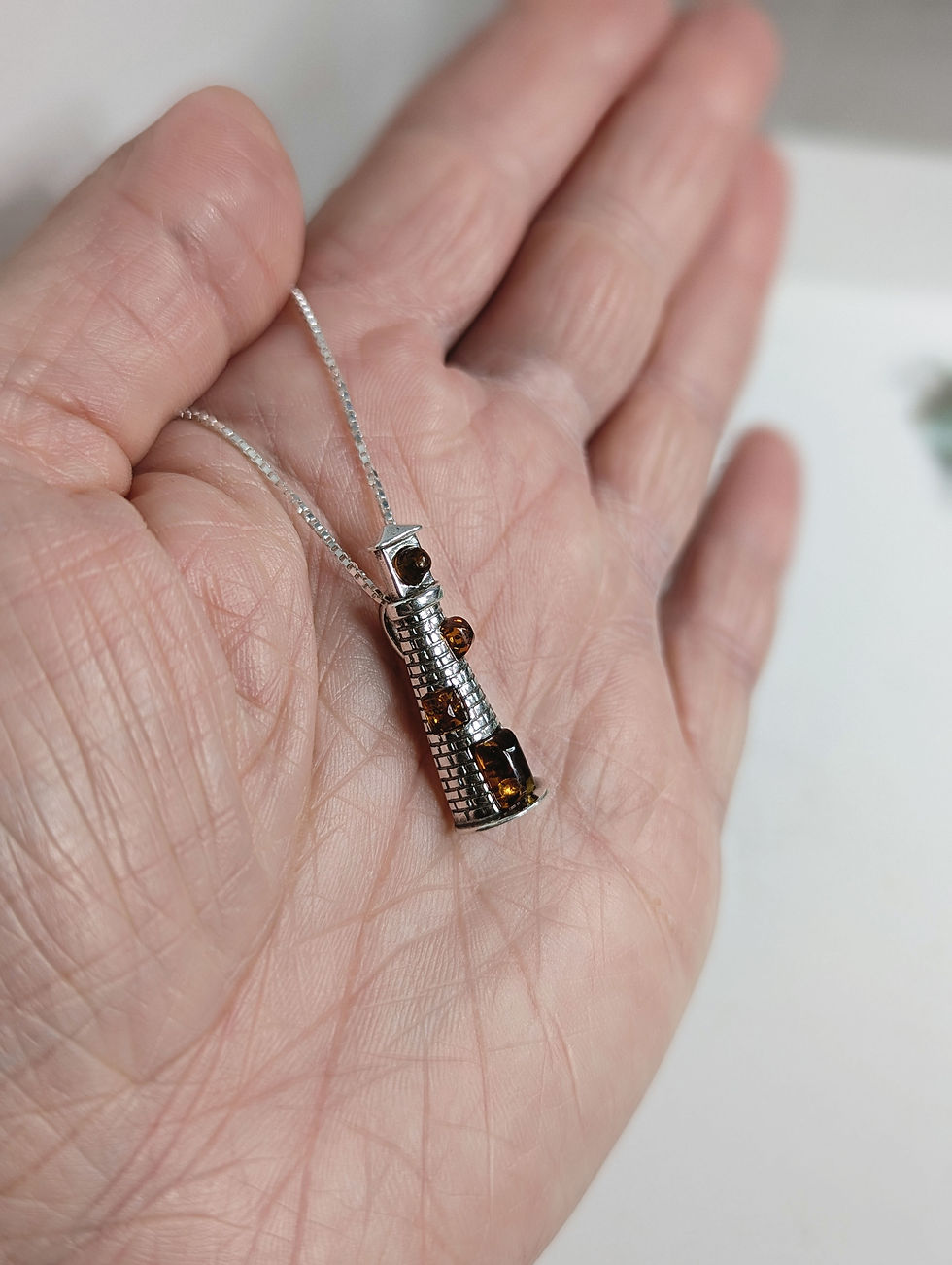 Thumbnail: Sterling Silver Lighthouse Pendant with Cognac Baltic Amber