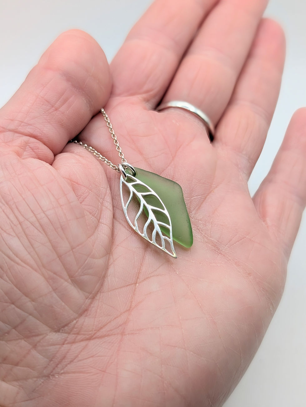 Thumbnail: Sterling Silver Leaf Charm Necklace with Green Suffolk Sea Glass