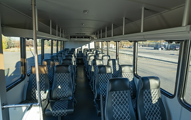 35-passenger executive coach interior with hand-stitched leather bucket seating. Premium group travel in Calgary.