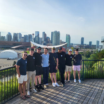 Visitors posing with downtown Calgary from Scotsman’s Hill during a YYCTOURS highlights tour