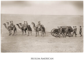 Muslim American soldiers on camels towing a gun carriage