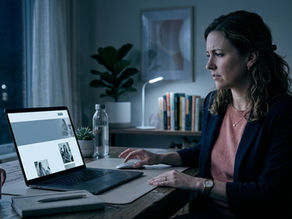 Woman entrepreneur staring at a finished project on her laptop, hesitant to launch, illustrating perfectionism in women entrepreneurs in the blog post by Asi Efros