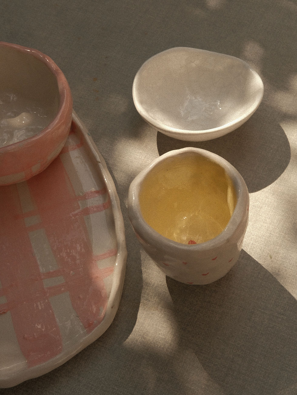 handmade ceramics cup and a handmade ceramics plate in the sunlight