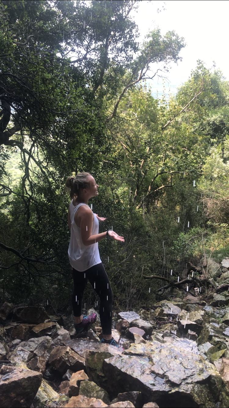 Kristen under a waterfall