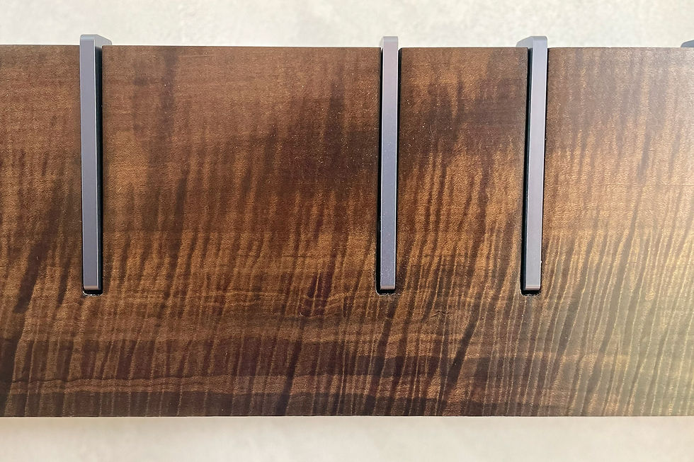 Thumbnail: Symbol X Maple - No. 8, detail of oxidized maple coat rack on plaster wall. Shows the figuring of the grain