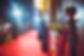 Gold coloured bollards lining a red carpet entrance.