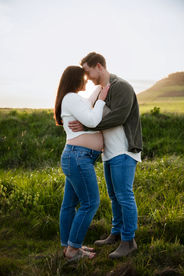 a pregnant couple with foreheads together