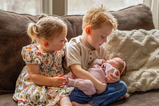 brother holding newborn sister