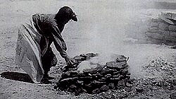 Image of Nampeyo, a famous Hopi potter firing some of her pots