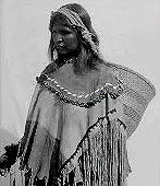This image shows a woman using the headband to carry a burden basket which can be seen behind her.