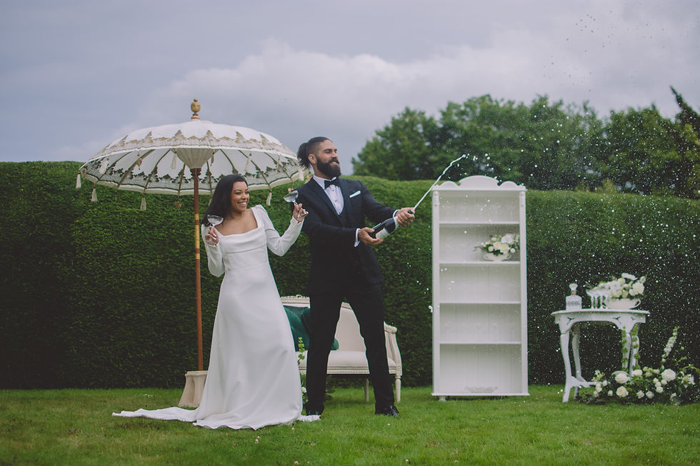 bride and groom spray champange peterstone court