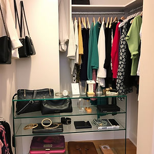 Wallets, jewelry, and secondary clothing inside a walking closet room displaying handbags,