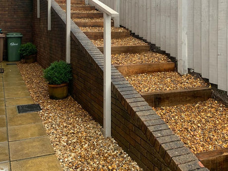 Oak railway sleeper steps and golden flint stone.  