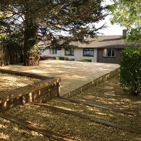 Decking platform, oak retaining wall and sleeper steps in woodland garden. Built by Ark Fencing & Garden Services, Cwmbran, South Wales.